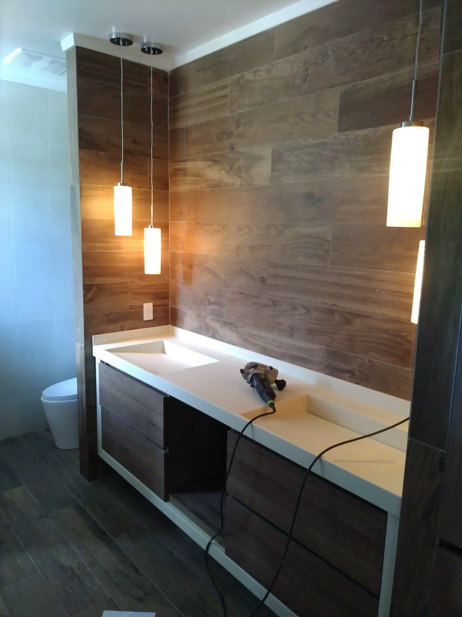 Completed bathroom installation with custom cabinetry in Mount Nevis