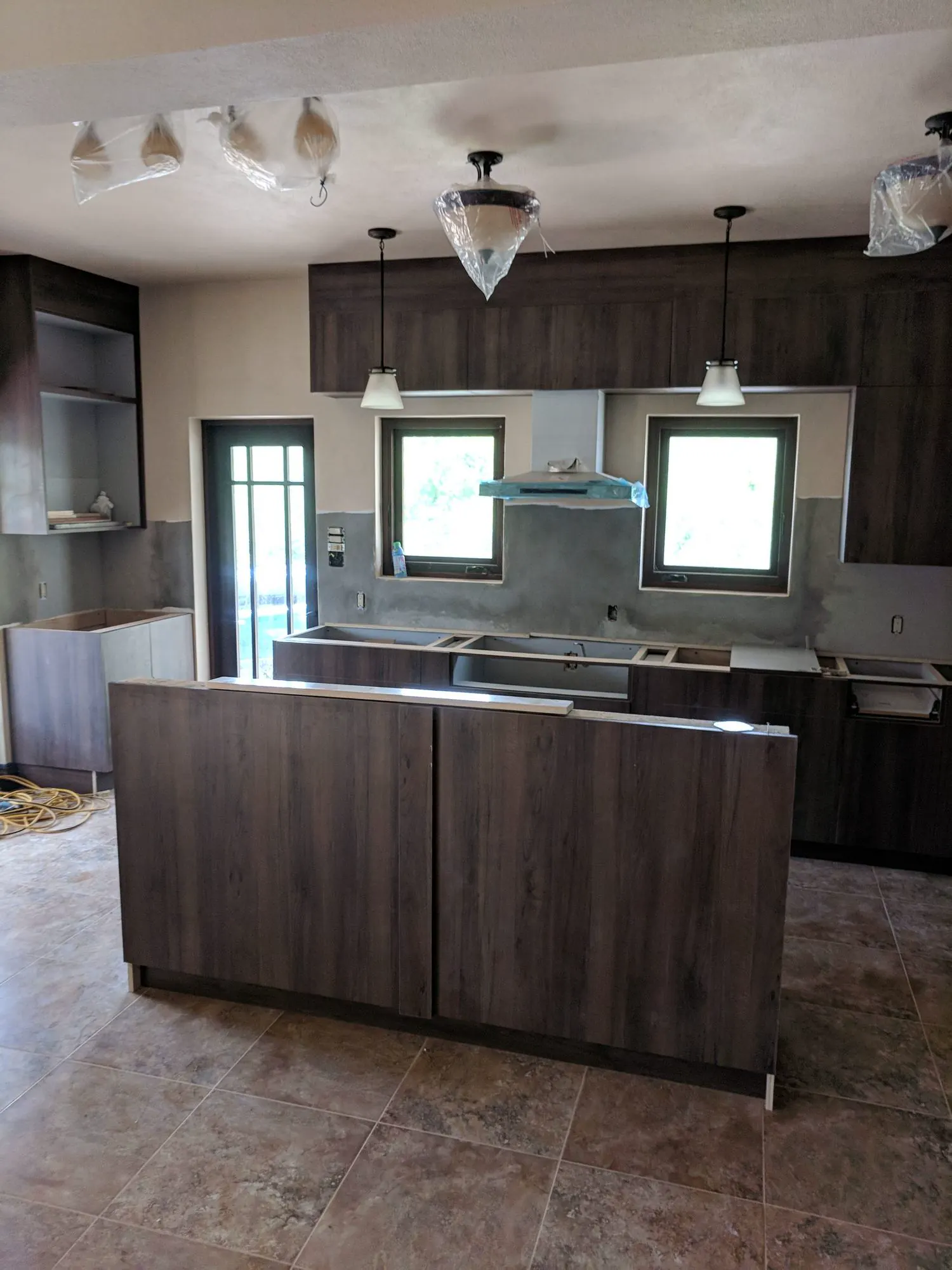 Family kitchen storage wall installation in Newcastle Nevis