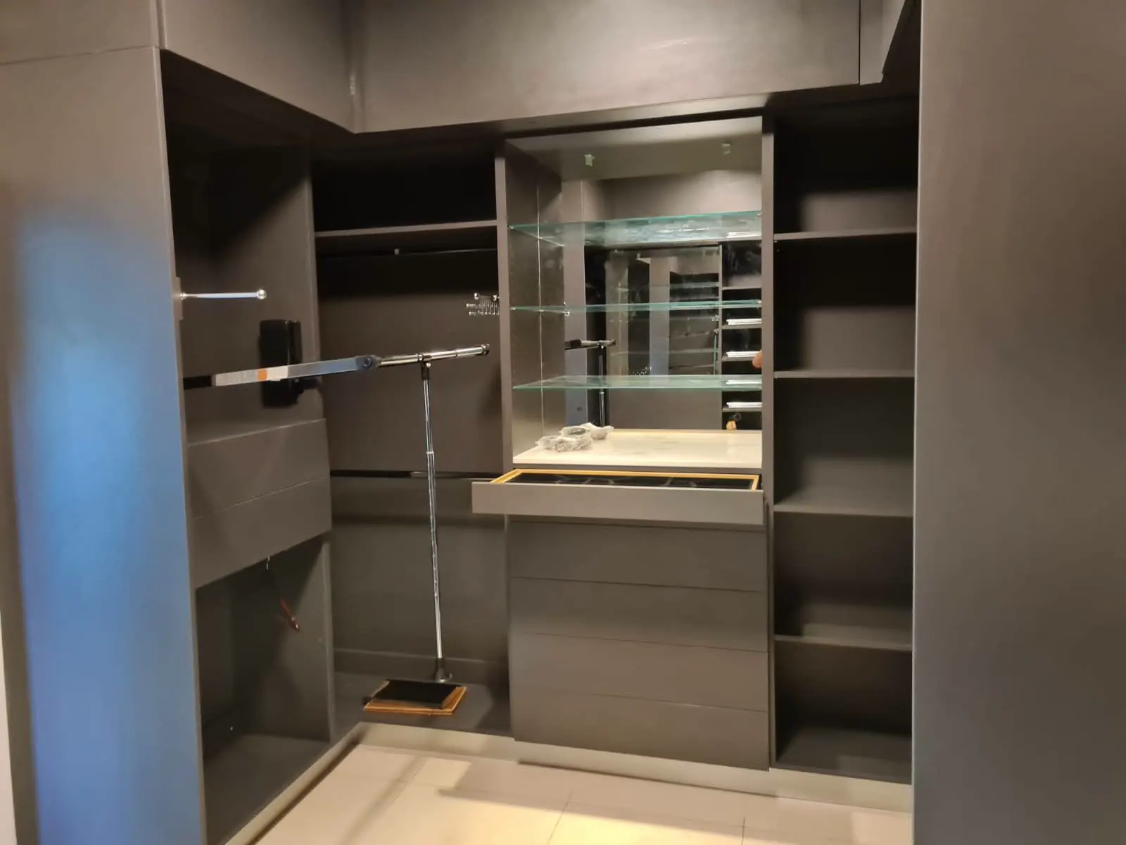 Walk-in wardrobe storage wall in Long Point Nevis residence